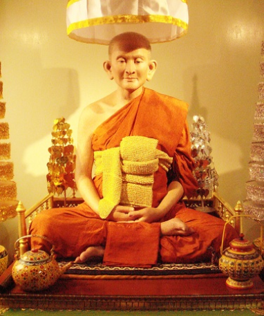 A statue of a monk
Description automatically generated